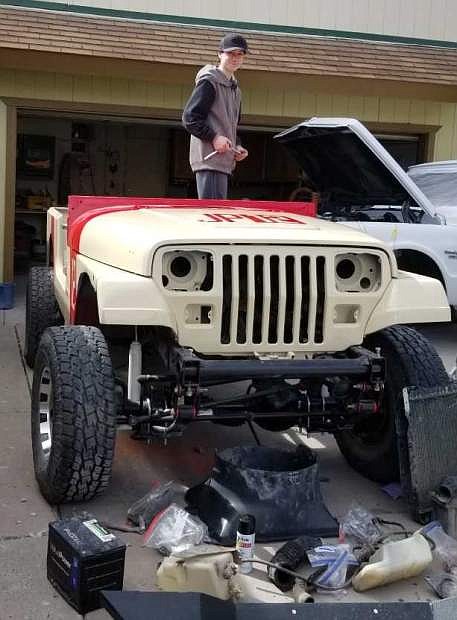 CHS student Nathan Reynolds works on his Jeep at home to make it new again with a makeover.