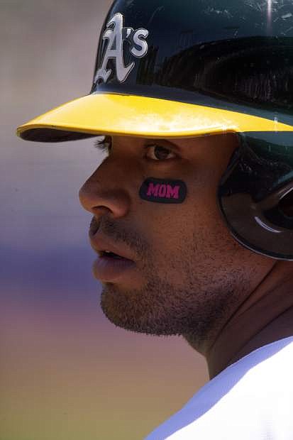 Oakland designated hitter Khris Davis sports Mother&#039;s Day-themed eye blacks as he waits on deck during the first inning against Cleveland on May 12 in Oakland.