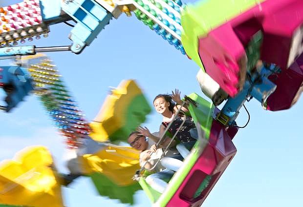 A pair of young ladies enjoy a ride at the RSVP Carnival Thursday evening.