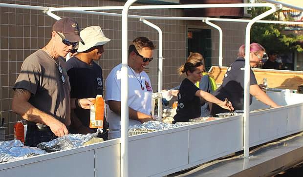 In addition to Kiwanians, volunteers from the community and Naval Air Station Fallon help serve breakfast on Labor Day.