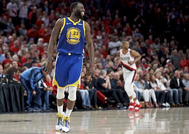 Golden State Warriors forward Draymond Green reacts after making a basket against the Portland Trail Blazers during the second half of Game 4 of the NBA basketball playoffs Western Conference finals Monday, May 20, 2019, in Portland, Ore. The Warriors won 119-117 in overtime. (AP Photo/Craig Mitchelldyer)