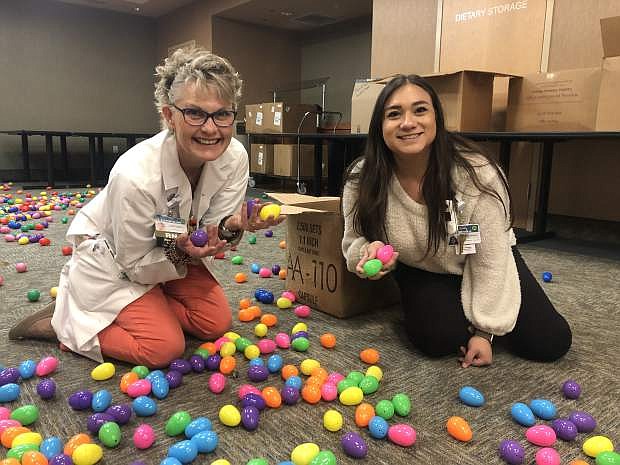 Cathy Smith, left, and Cristina Ramirez, employees of Carson Tahoe Health, demonstrate one of the reasons their company took second place in the extra-large employer category at the 12th annual Greater Reno-Tahoe Best Places to Work event on April 25.
