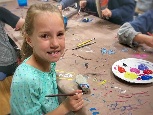 Lucy Bauerle, Fritsch Elementary School second grader, shows her creativity painting a rock.