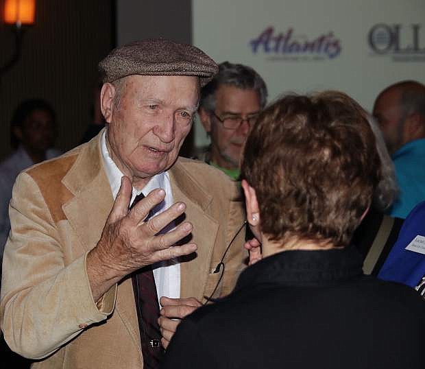 Mitka Kalinksi speaks to a woman who attended his presentation.