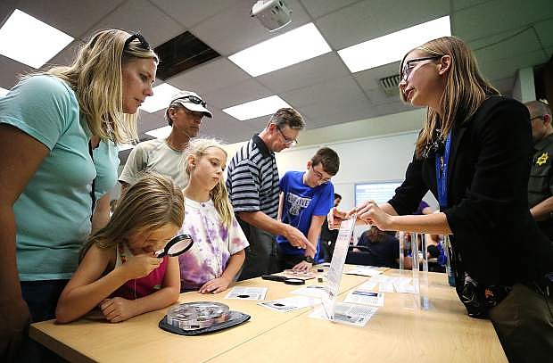 Librarian Maria Klesta, right, talks with Shannon Schnaible and her daughters Amelia, 6, and Cadence, 8, during the NASA@ My Library event at the Carson City Library on Aug. 2, 2018.