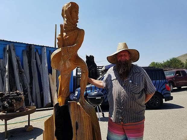 Matthew Welter, sculptor and owner, Timeless Sculptures, stands with one of his sculptures, Minute Man.