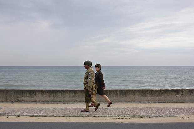 Enthusiasts walk on the waterfront of Saint-Laurent-sur-Mer, Tuesday, June 4, 2019, in Normandy. Extensive commemorations are being held in the U.K. and France this week to honor the nearly 160,000 troops from Britain, the United States, Canada and other nations who landed in Normandy on June 6, 1944 in history&#039;s biggest amphibious invasion. (AP Photo/Thibault Camus)