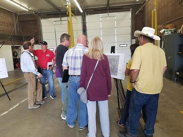 People gathered around a draft design to hear a presentation on proposed changes at Ross Gold Park during a public meeting Thursday at Fire Station #53.