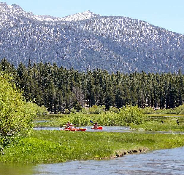 Kayakers make their way down the Upper Truckee River Thursday afternoon in South Lake Tahoe.