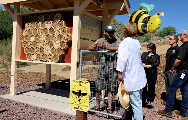 Representatives from the Greenhouse Project speak with members of the project and demonstrate the newly unveiled bee habitat to Mayor Bob Crowell and other city officials Friday behind the Carson Tahoe Cancer Center.
