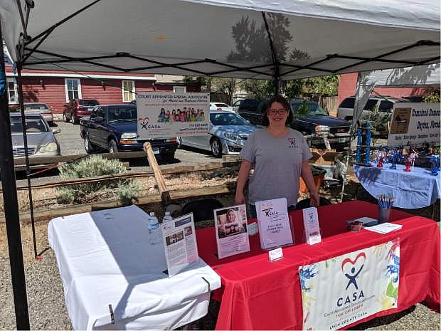 Kelcy Meyer, executive director of Lyon County&#039;s Court Appointed Special Advocates program, recruits for more volunteers at the Oodles of Noodles event on June 1 in Dayton. Lyon&#039;s program is in critical need for more adults to assist with its caseload of 27 children.