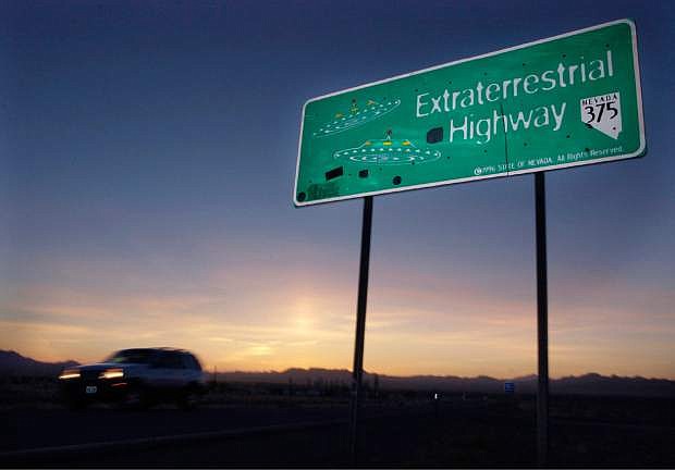 FILE - In this April 10, 2002, file photo, a vehicle moves along the Extraterrestrial Highway near Rachel, Nev., the closest town to Area 51. The U.S. Air Force has warned people against participating in an internet joke suggesting a large crowd of people &quot;storm Area 51,&quot; the top-secret Cold War test site in the Nevada desert. (AP Photo/Laura Rauch, File)