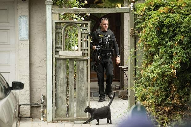 A police officer leaves the family home of Gilroy Garlic Festival gunman Santino William Legan on Monday, July, 29, 2019, in Gilroy, Calif. The Sunday evening shooting left at least three people, including a 6-year-old boy, dead and wounding about 15 others. (AP Photo/Noah Berger)