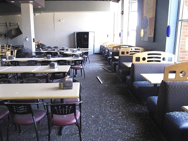 Shattered glass and other damage is seen in the first-floor cafeteria at a University of Nevada, Reno dormitory, Thursday, July 11, 2019, in Reno, Nev., where a July 5 natural gas explosion blew out walls and windows. School officials gave members of the media their first up-close look at the exterior and interior damage on Thursday . Less than a dozen people suffered minor injuries in the explosion at the mostly empty dorm. (AP Photo/Scott Sonner)