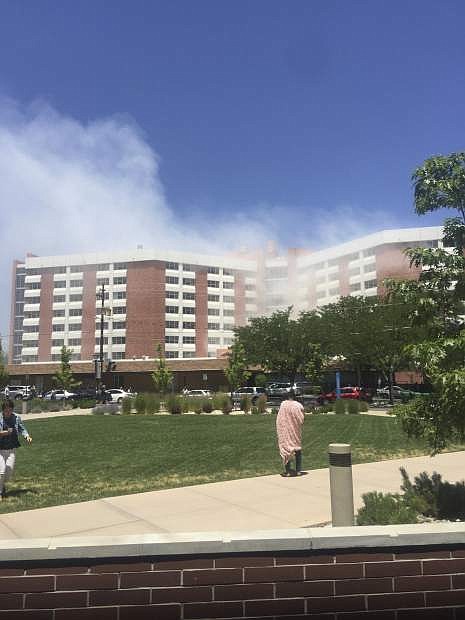 Plumes of smoke from an explosion inside a residence hall at the University of Nevada, Reno in Reno, Nev., is visible on Friday, July 5, 2019. Police referred to the incident as a &quot;utilities accident.&quot; There were no immediate reports of injuries. (Raymond Floyd via The AP)