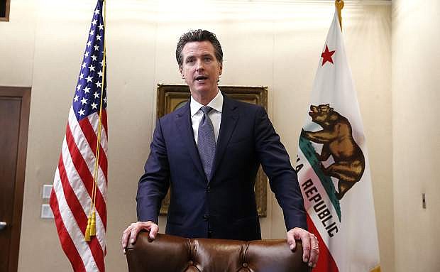 California Gov. Gavin Newsom answer questions concerning a wildfire measure he signed, eft, in Sacramento, Calif., Friday, July 12, 2019. The bill AB1054, is aimed at stabilizing the state&#039;s electric utilities in the face of devastating wildfires caused by their equipment. (AP Photo/Rich Pedroncelli)