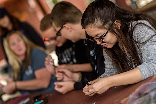 Morningstarr Vella, 17, makes a bracelet June 28 at the Nevada Statewide Youth Summer Camp, at Stateline.
