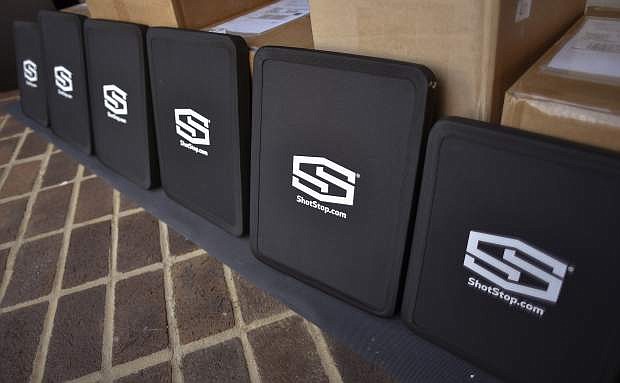 Some of the 3-lbs bulletproof backpack inserts for Sullivan County Schools students that were donated by ShotStop Ballistics, in conjunction with Florida-based nonprofit organization Blue Blood Brotherhood, Friday, Aug. 9, 2019, in Blountville, Tenn. Safety is high on the minds of many parents, especially after two back-to-back mass shootings in El Paso and Dayton, Ohio that left multiple people dead. (Andre Teague/Bristol Herald Courier via AP)