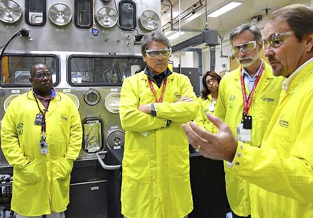 FILE - In this May 10, 2017, file photo provided by the Los Alamos National Laboratory, U.S. Secretary of Energy Rick Perry, second from left, accompanied by Laboratory Director Charlie McMillan, second from right, learns about capabilities at the Los Alamos Laboratory Plutonium Facility, from Jeff Yarbrough, right, Los Alamos Associate Director for Plutonium Science and Manufacturing, in Los Alamos. A federal appeals court has ruled against Nevada in a legal battle over the U.S. government&#039;s secret shipment of weapons-grade plutonium to a site near Las Vegas. A three-judge panel of the 9th U.S. Circuit Court of Appeals on Tuesday, Aug. 13, 2019, denied the state&#039;s appeal after a judge refused to block any future shipments to Nevada. The court in San Francisco says the matter is moot because the Energy Department already sent the radioactive material and has promised that no more will be hauled there. (Los Alamos National Laboratory via AP, File)