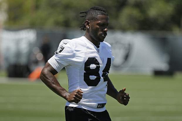 FILE - In this June 11, 2019, file photo, Oakland Raiders wide receiver Antonio Brown participates in an NFL football minicamp in Alameda, Calif. Antonio Brown returned to the Oakland Raiders training camp facility, Tuesday, Aug. 13, 2019, after missing time to see a specialist for his frost-bitten feet and losing a grievance with the NFL over the use of a helmet. (AP Photo/Eric Risberg, File)