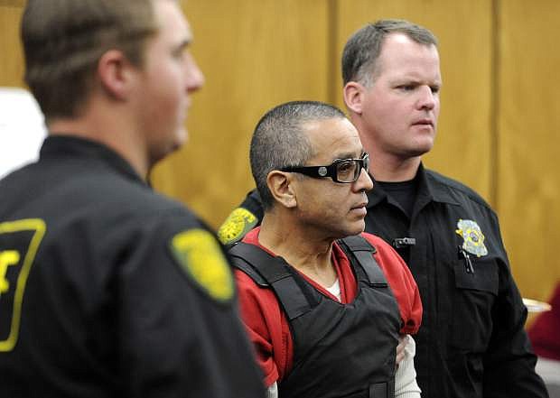 FILE - In this Nov. 17, 2011 file photo, Vagos motorcycle gang member Ernesto Gonzalez is led from district court under heavy security in Reno, Nev., after pleading guilty in the shooting death of Hells Angels member Jeffrey &quot;Jethrow&quot; Pettigrew. A jury in Las Vegas heard two vastly different views of a federal racketeering trial that opened Monday, Aug. 12, 2019, for eight Vagos biker gang members including Gonzalez stemming from a 2011 shootout that killed a rival Hells Angels leader in a Nevada casino. (David B.Parker/The Reno Gazette-Journal via AP, File)