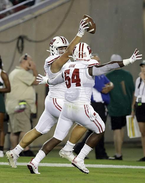 Wisconsin defensive end Matt Henningsen celebrates with linebacker Chris Orr (54) after Henningsen intercepted a South Florida pass and returned it for a touchdown during the first half of an NCAA college football game Friday, Aug. 30, 2019, in Tampa, Fla. (AP Photo/Chris O&#039;Meara)