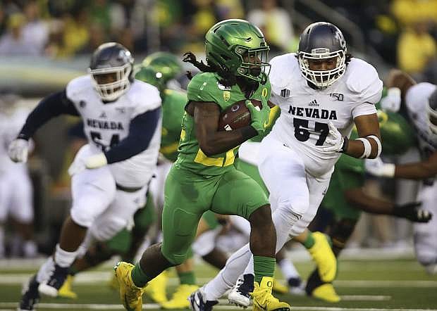 Wolf Pack defenders pursue Oregon&#039;s Darrian Felix in the fourth quarter Sept. 7 in Eugene, Ore. Nevada will look to get back on track Saturday against Weber State.