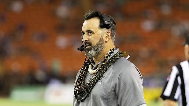 Hawaii head coach Nick Rolovich glances up at the scoreboard during the first half of an NCAA college football game against Central Arkansas, Saturday, Sept. 21, 2019, in Honolulu. (AP Photo/Eugene Tanner)