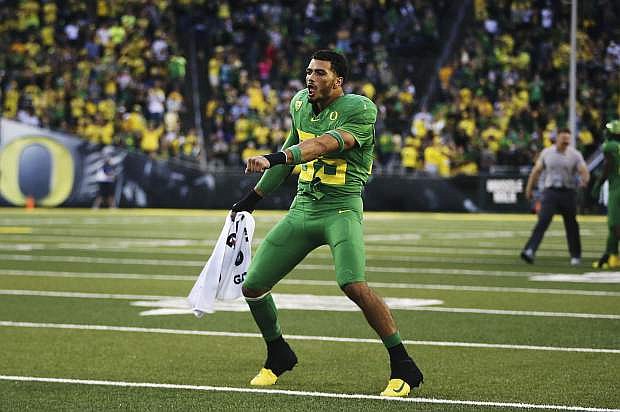 Oregon&#039;s Troy Dye dances on the field between the third and fourth quarters of the NCAA college football game against Nevada Saturday, Sept. 7, 2019, in Eugene, Ore. (AP Photo/Chris Pietsch)