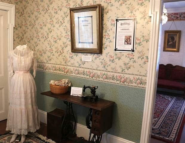 The Wilcox and Gibbs sewing machine in the middle room of the Foreman-Roberts House was built circa 1870 and was donated to the Carson City Historical Society by Leon and Cora Cowan in 2015. The framed resolution above it recognizes Carson City founder Abraham Curry. Curry was a member of the Improved Order of Red Men consisting of various &quot;tribes&quot; in California and Nevada. The resolution provides a statement of sympathy from the Red Men after Curry&#039;s death in October 1873.