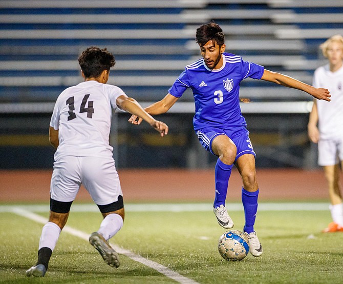 Carson&#039;s Saeed Mobaligh pulls the ball back away from Galena&#039;s Erik Rodriguez during the NIAA Northern Division 1 soccer match between the Galena Grizzlies and Carson High Senators at Carson High School.