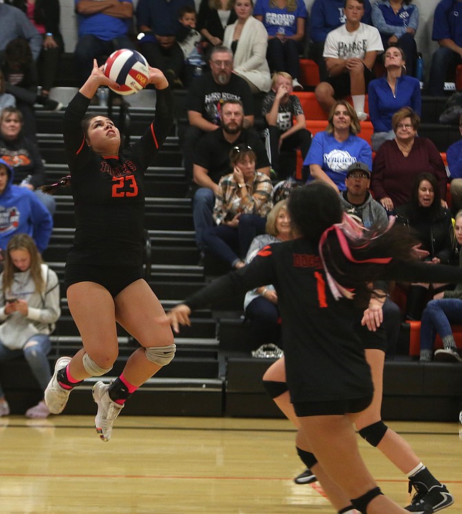 Douglas&#039; Fiona Mora (23) sets the ball for her two approaching teammates Thursday evening against Carson. 