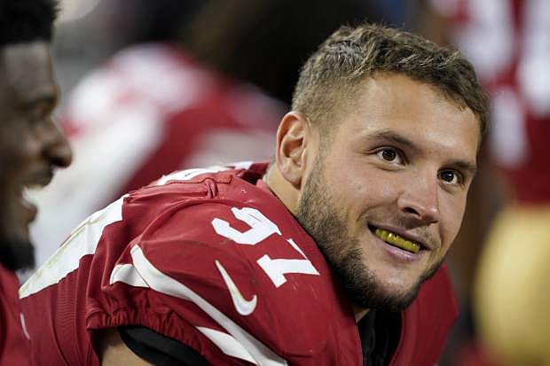San Francisco 49ers defensive end Nick Bosa (97) smiles on the sideline during the second half of an NFL football game against the Cleveland Browns in Santa Clara, Calif., Monday, Oct. 7, 2019. (AP Photo/Tony Avelar)