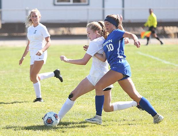 Reese Mackenzie battles for possession Saturday with a Damonte Ranch defender. Carson fell to Damonte Ranch 3-1.