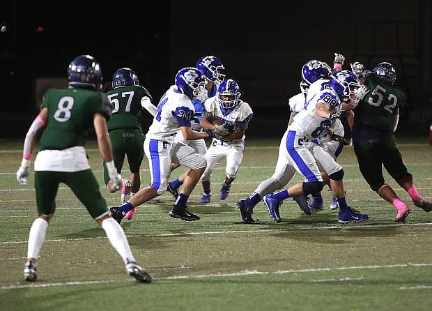 Ivan Villegas (45) hits a hole created by the Carson offensive line last Friday against Damonte Ranch. Villegas and the Carson running game will be a big importance in the Senators&#039; contest against Wooster Thursday.