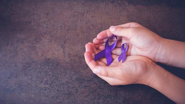 hands holding Purple ribbons,toning copy space background, Alzheimer&#039;s disease, Pancreatic cancer, Epilepsy awareness, Hodgkin&#039;s Lymphoma awareness, panoramic banner