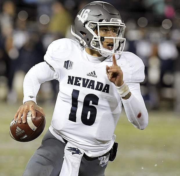 Nevada quarterback Malik Henry (16) scrambles out of the pocket during an NCAA college football game against Utah State on Saturday, Oct. 19, 2019, in Logan, Utah. (Eli Lucero/The Herald Journal via AP)