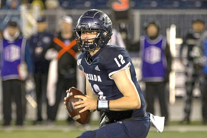 Nevada quarterback Carson Strong (12) rolls out against Hawaii in the first half of an NCAA college football game in Reno, Nev., Saturday, Sept. 28, 2019. (AP Photo/Tom R. Smedes