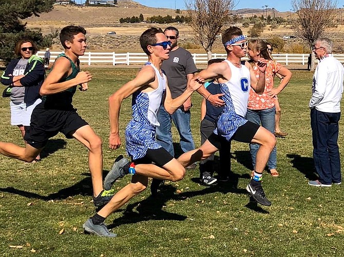 Ethan Bauerle, left, and Jacob Crossman, right, sprint toward the finsh at the Sierra League cross country meet Friday afternoon in Reno.