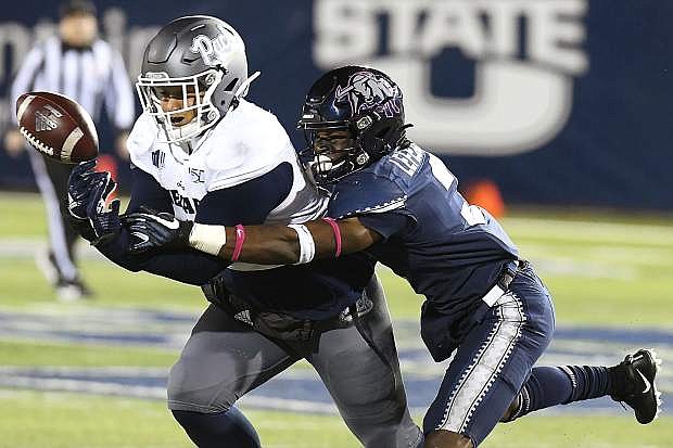 Utah State safety Troy Lefeged Jr., right, breaks up a pass intended for Nevada tight end Crishaun Lappin (9) on Saturday, in Logan, Utah.