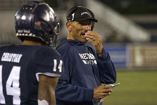 Nevada head coach Jay Norvell talks with wide receiver Dominic Christian during the game against Hawaii on Sept. 28.