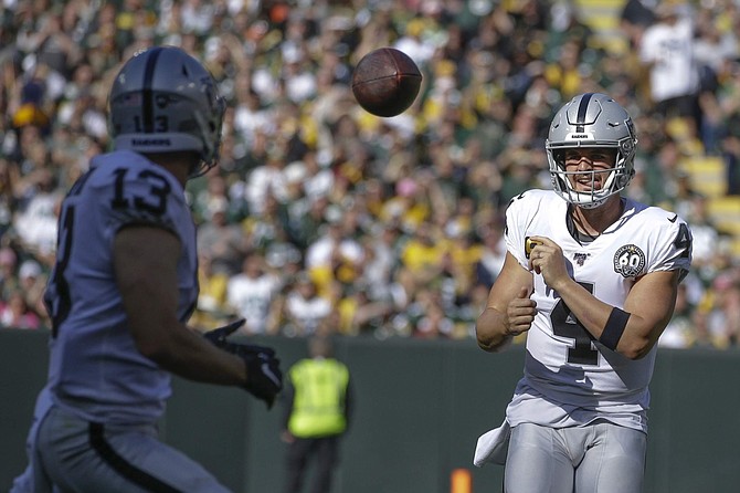 Oakland Raiders&#039; Derek Carr throws to Hunter Renfrow during the first half of an NFL football game against the Green Bay Packers Sunday, Oct. 20, 2019, in Green Bay, Wis. (AP Photo/Jeffrey Phelps)
