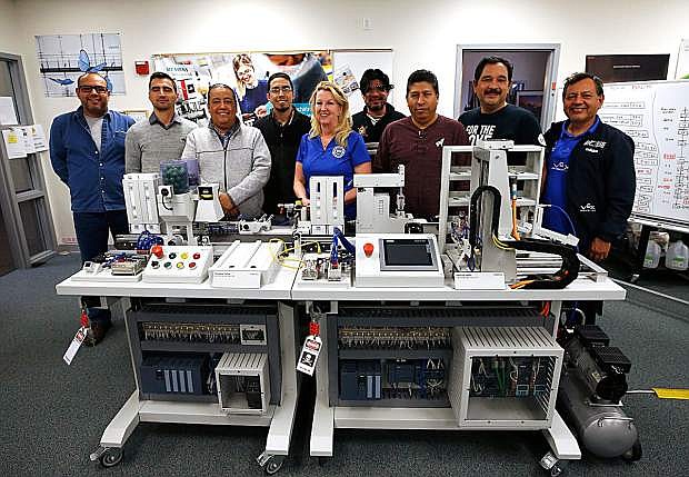 Professor Emily Howarth and eight university instructors from Tamaulipas, Mexico, take a break from an accelerated Mechatronics certification training program Wednesday at Western Nevada College in Carson City.