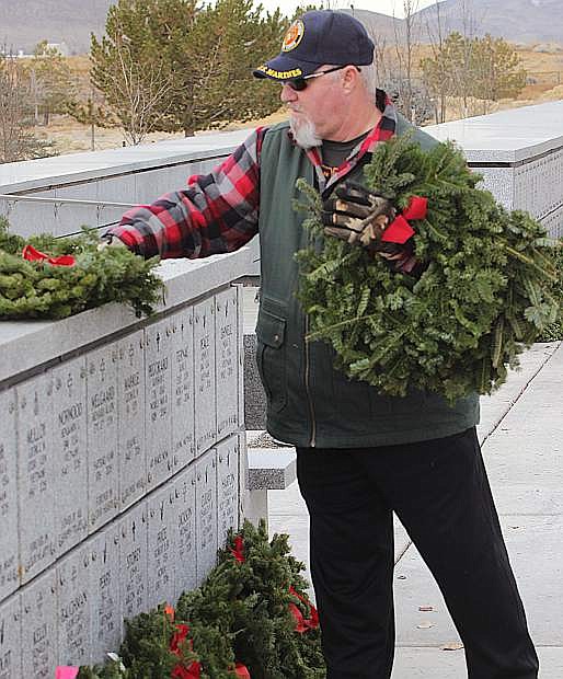 A Marine Corps veteran places wreaths at the columbarium wall during the 2018 remembrance.