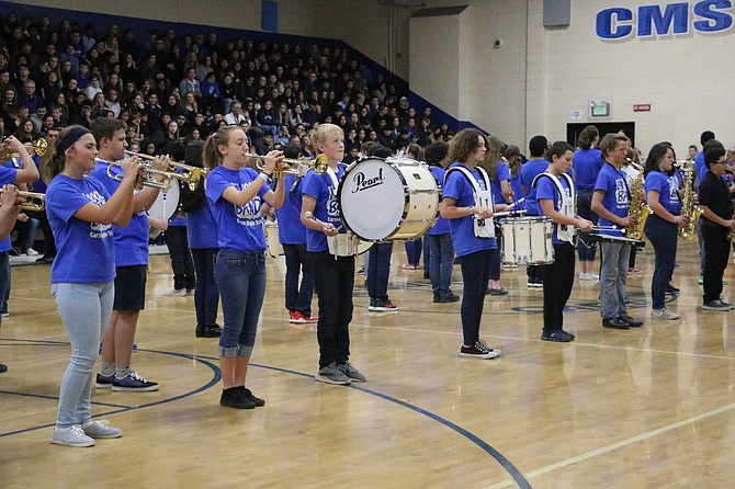 The Carson Middle School band performs Thursday before their band teacher Nicolas Jacques is announced as a 2019-20 Milken Educator Award recipient in their school gym.
