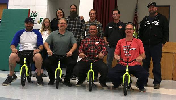 Local groups gather Friday for the launch of Nevada&#039;s first public school All Kids Bike program and donation to Pinon Hills Elementary School in Minden. Contributors included (back row) Jen King, Glen King, Kris Barnes, Bob Paugh and Kyle Brewer. Pictured in the front row, from left, are parent David Stern, principal Jason Reid, Josh Sheehan and Pinon Hills physical education teacher Nyls Rothfusz.