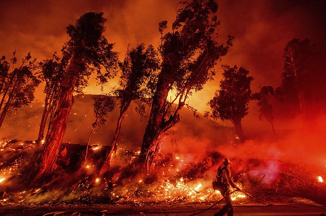 Flames from a backfire consume a hillside as firefighters battle the Maria Fire in Santa Paula, Calif., on Friday, Nov. 1, 2019. According to Ventura County Fire Department, the blaze has scorched more than 8,000 acres and destroyed at least two structures. (AP Photo/Noah Berger)