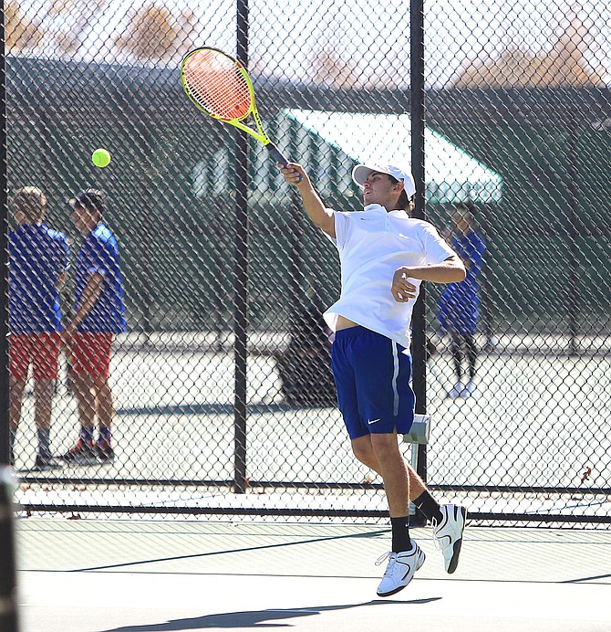 Bradley Wiggins jumps to topspin a forehand during the 4A Northern Regional doubles semifinal match. Wiggins and Eric Tomita won their semifinal match, advancing to the state tournament.