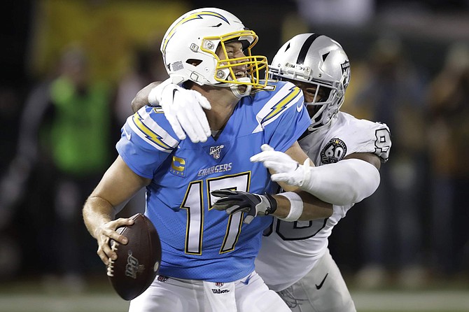 Los Angeles Chargers quarterback Philip Rivers (17) is sacked by Oakland Raiders defensive end Clelin Ferrell during the second half of an NFL football game in Oakland, Calif., Thursday, Nov. 7, 2019. (AP Photo/Ben Margot)