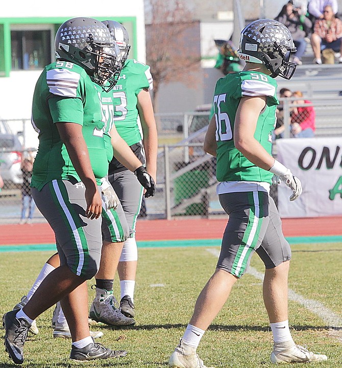 From left, offensive linemen Sione Otuafi, Damein Towne and Thomas Steele head toward the line of scrimmage against Virgin Valley.